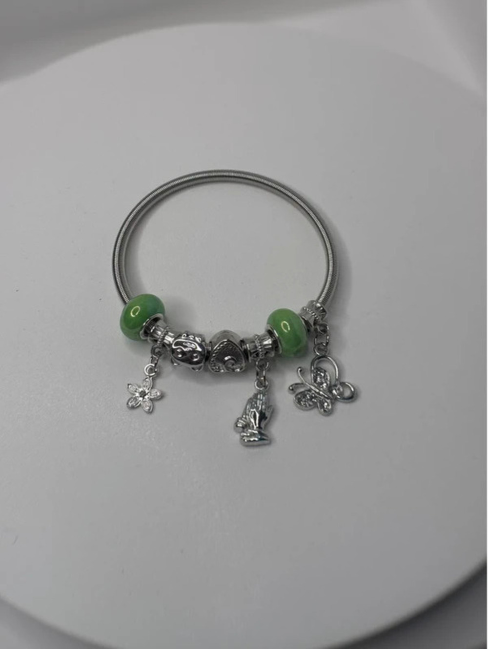 Silver tone and green charm bracelet
